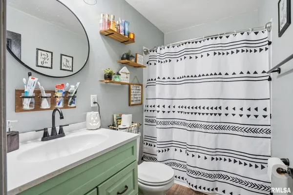 a bathroom with a toilet a sink and a mirror