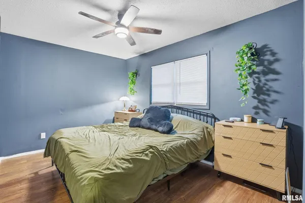 a bedroom with a bed and a potted plant