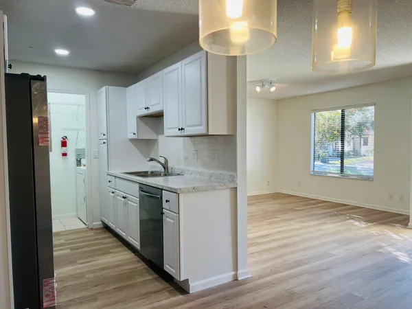 a kitchen with stainless steel appliances granite countertop a stove and a refrigerator