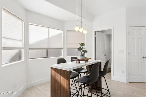 a dining room with furniture a chandelier and wooden floor