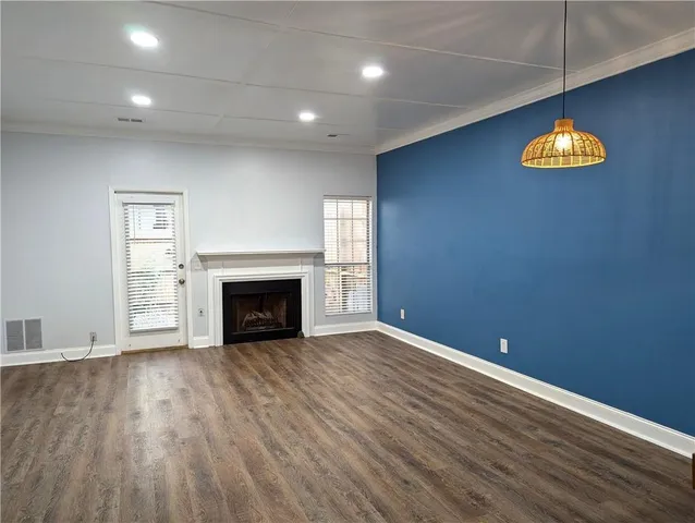 an empty room with a fireplace and painted walls