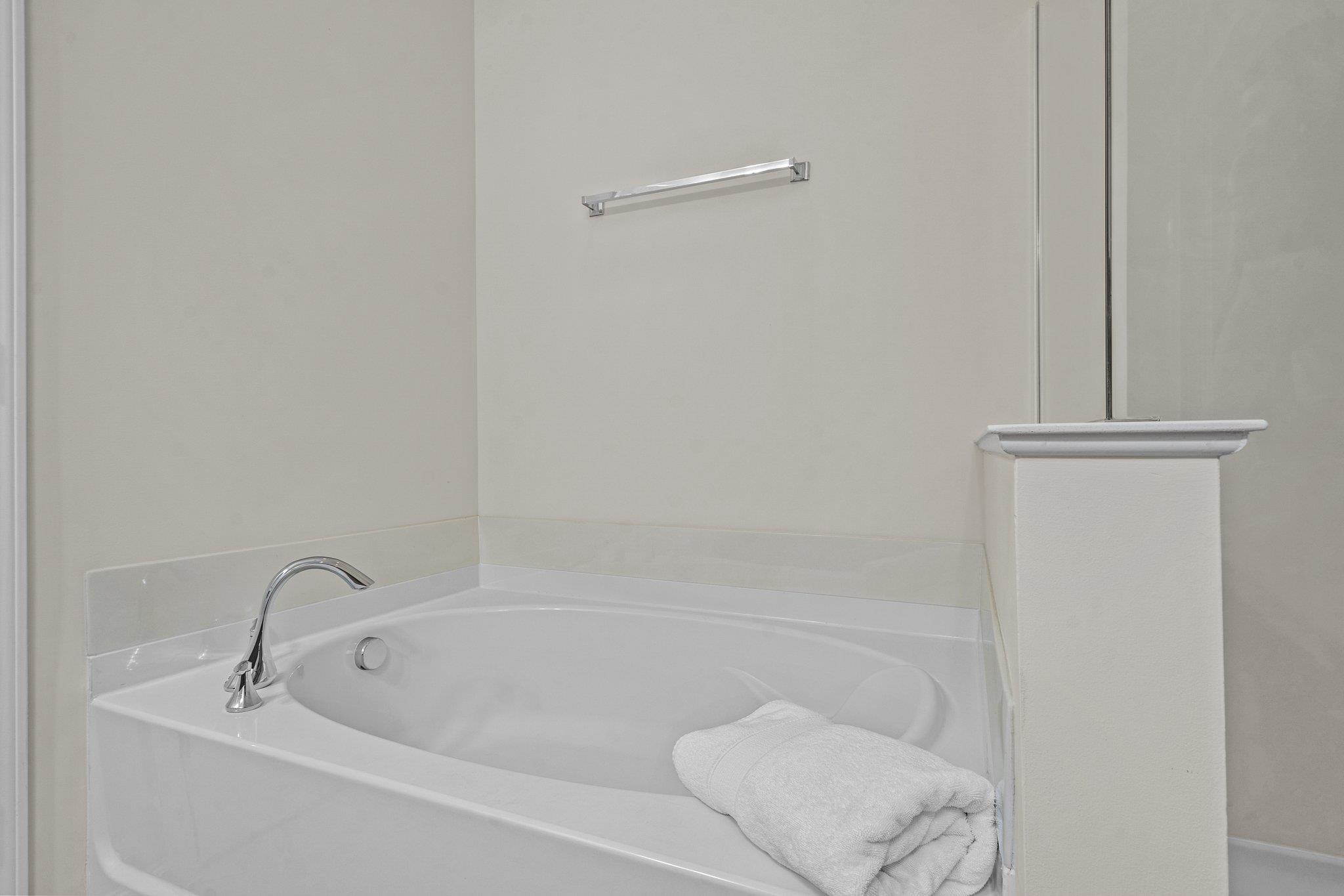 10109 Falls Meadow Court Raleigh, NC 27617 - Photo 19 of 37 a white bath tub sitting next to a shower