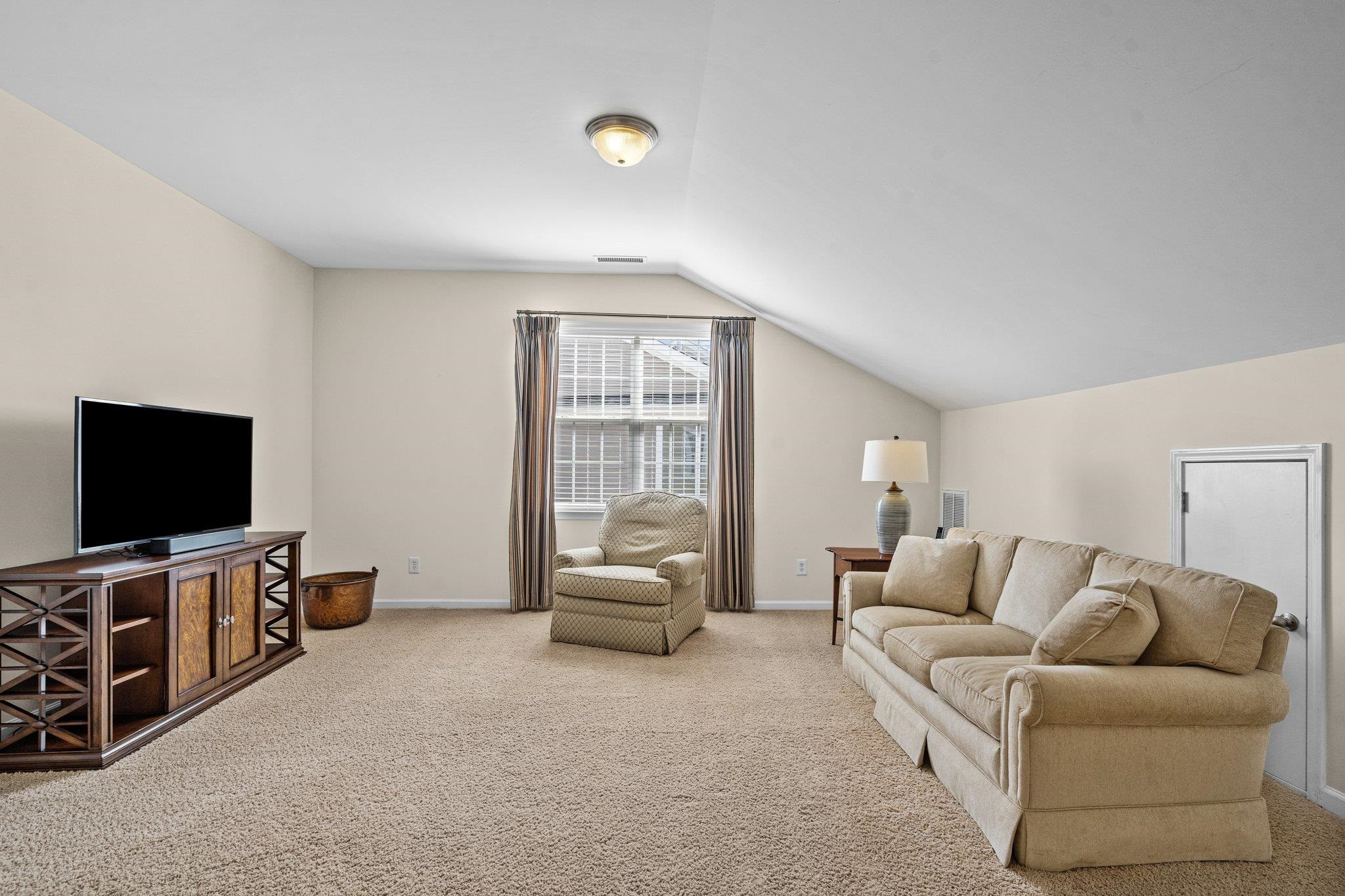 10109 Falls Meadow Court Raleigh, NC 27617 - Photo 23 of 37 a living room with furniture and a flat screen tv