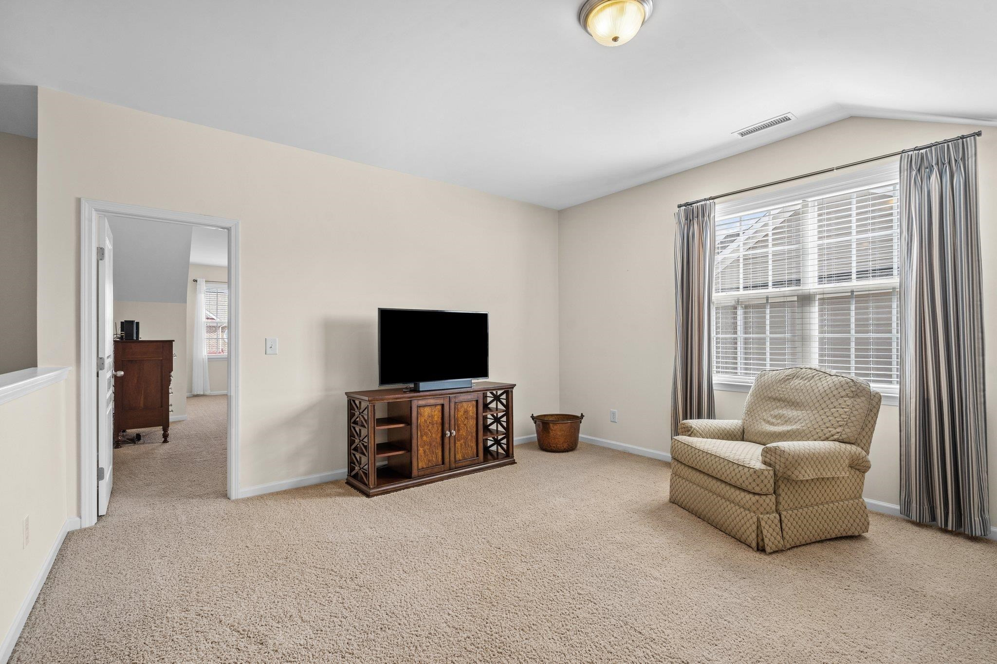 10109 Falls Meadow Court Raleigh, NC 27617 - Photo 25 of 37 a living room with furniture and a flat screen tv