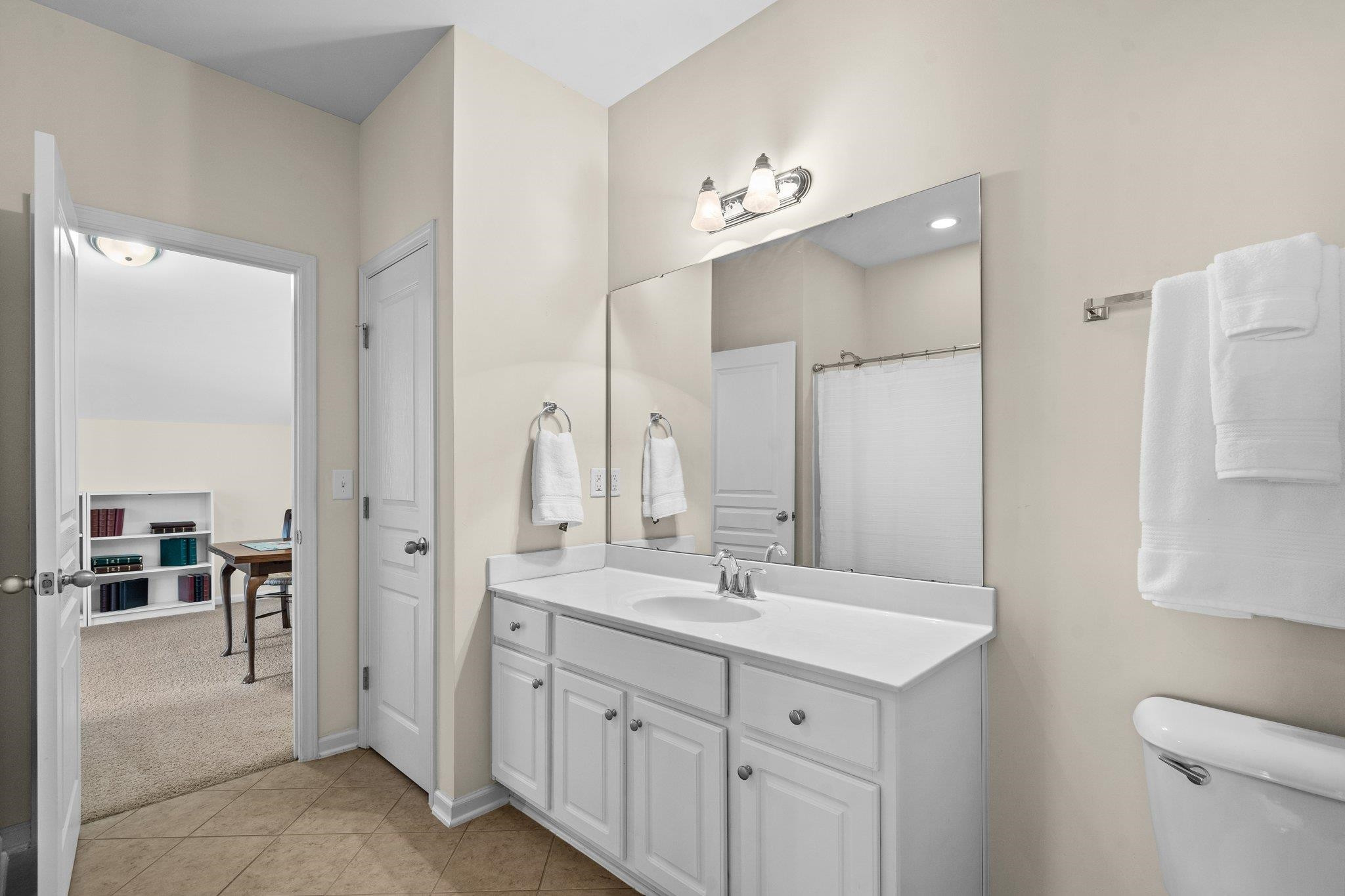 10109 Falls Meadow Court Raleigh, NC 27617 - Photo 28 of 37 a bathroom with a double vanity sink a mirror and a shower