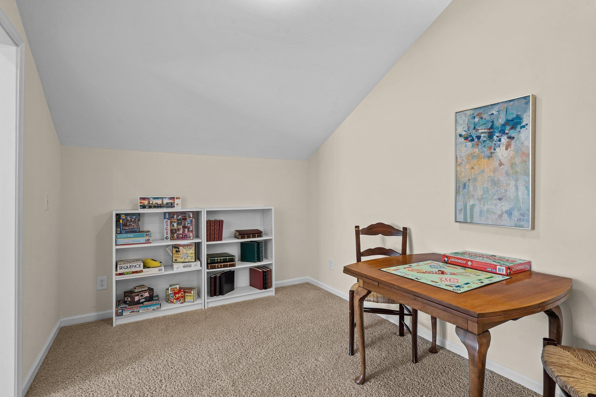 10109 Falls Meadow Court Raleigh, NC 27617 - Photo 29 of 37 a room with furniture and a bookshelf