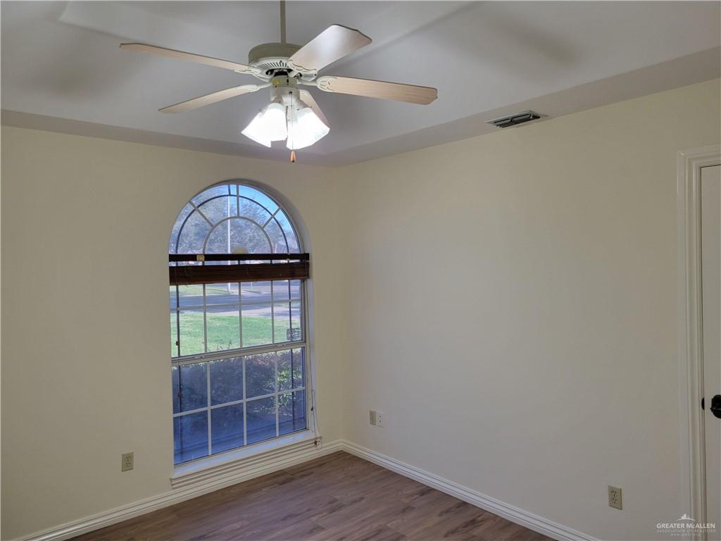 1605 Melissa Rae Drive Mission, TX 78572 - Photo 18 of 27 an empty room with wooden floor and chandelier fan