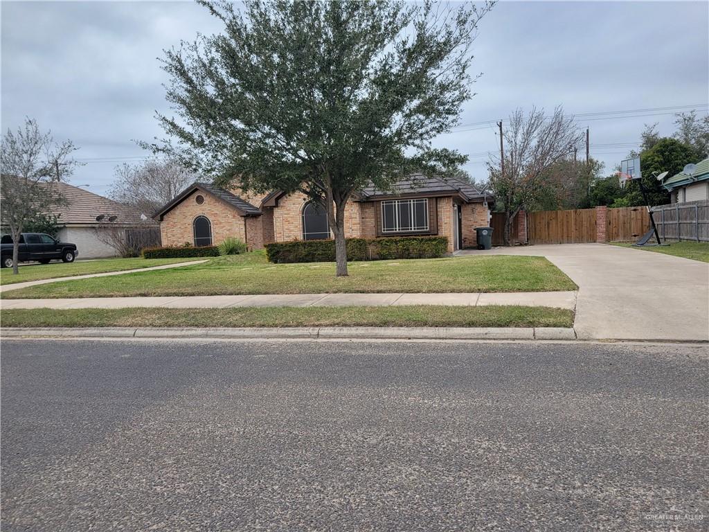 1605 Melissa Rae Drive Mission, TX 78572 - Photo 2 of 27 a brick house with a large tree in front of it