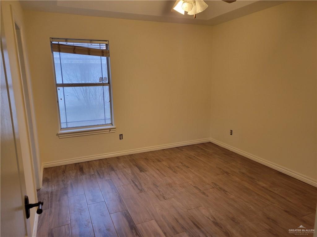 1605 Melissa Rae Drive Mission, TX 78572 - Photo 9 of 27 a view of an empty room with wooden floor and a window