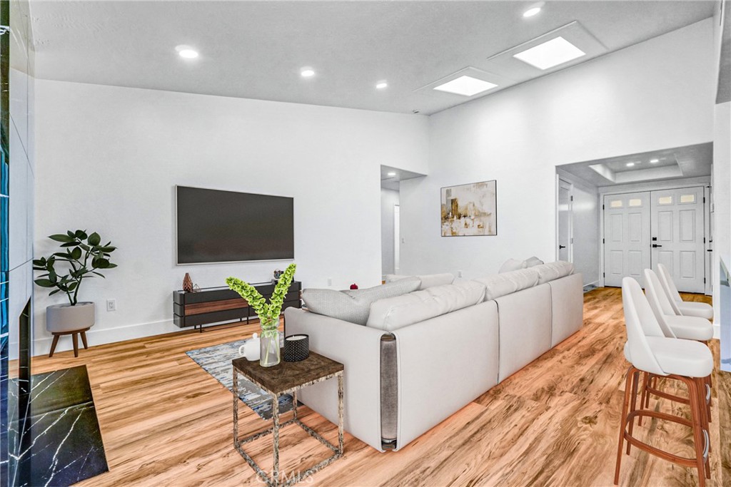 17472 Bellport Circle Huntington Beach, CA 92649 - Photo 11 of 23 a living room with furniture a flat screen tv and a potted plant
