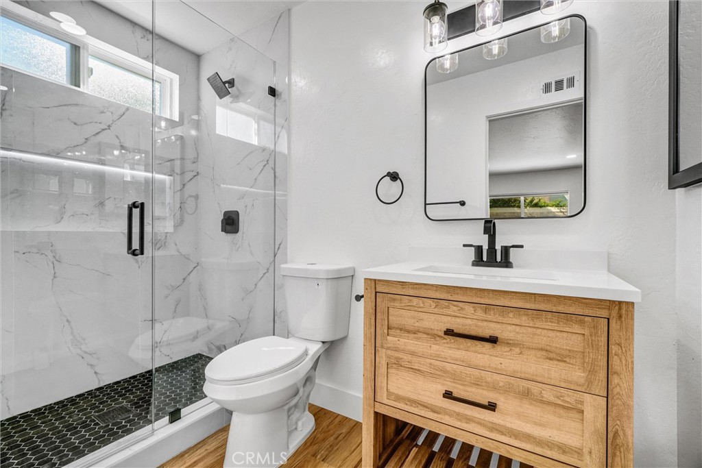 17472 Bellport Circle Huntington Beach, CA 92649 - Photo 12 of 23 a bathroom with a sink a toilet and shower