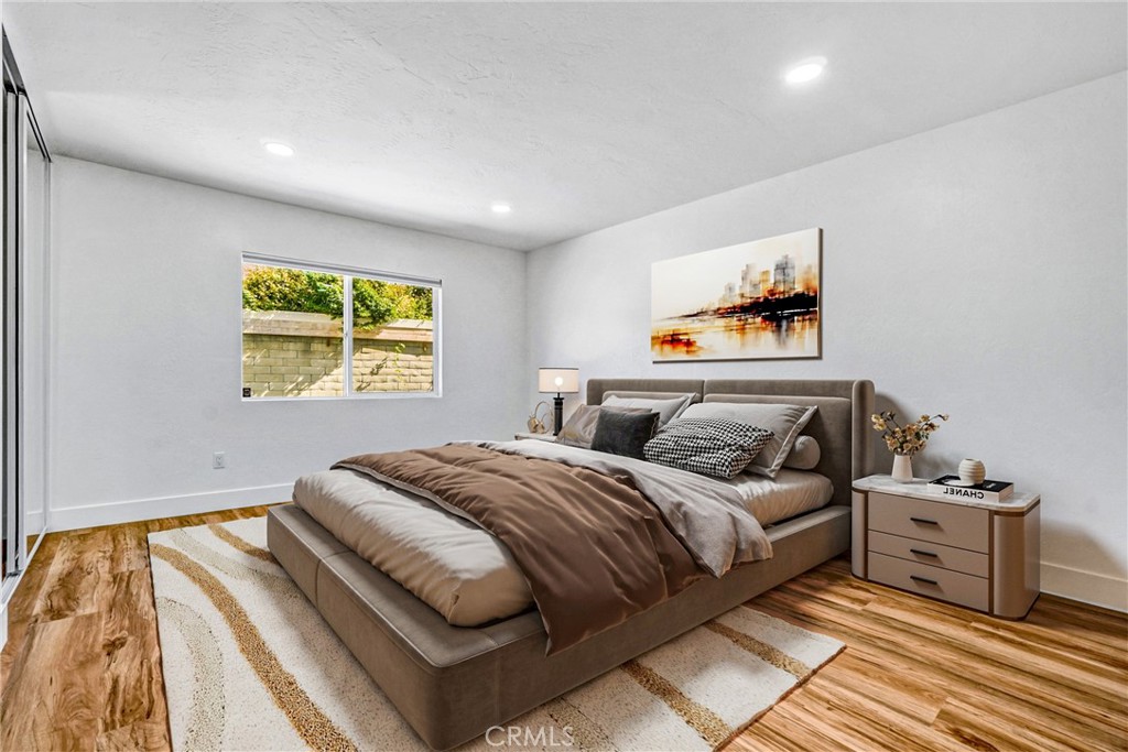 17472 Bellport Circle Huntington Beach, CA 92649 - Photo 13 of 23 a bedroom with a bed and a painting on the wall