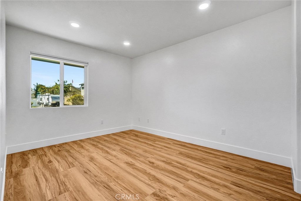 17472 Bellport Circle Huntington Beach, CA 92649 - Photo 14 of 23 an empty room with wooden floor and window