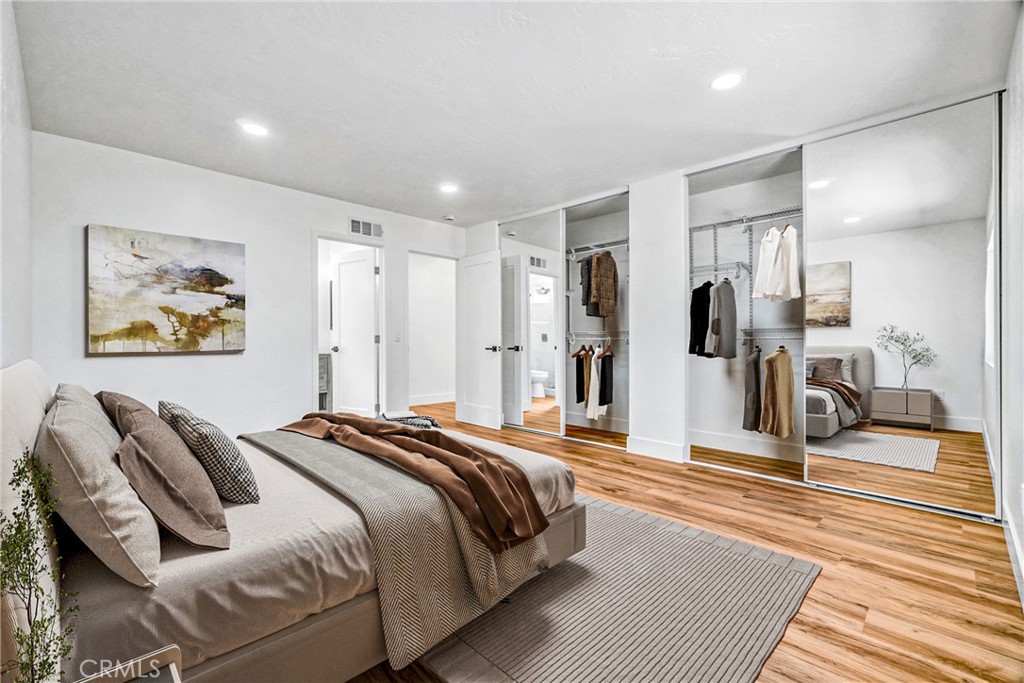 17472 Bellport Circle Huntington Beach, CA 92649 - Photo 15 of 23 a spacious bedroom with a bed and glass walk in closet