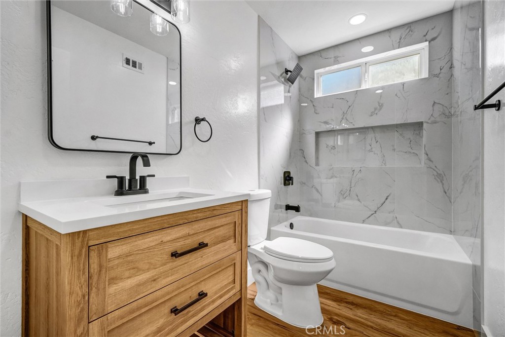 17472 Bellport Circle Huntington Beach, CA 92649 - Photo 16 of 23 a bathroom with a sink a toilet and a bathtub