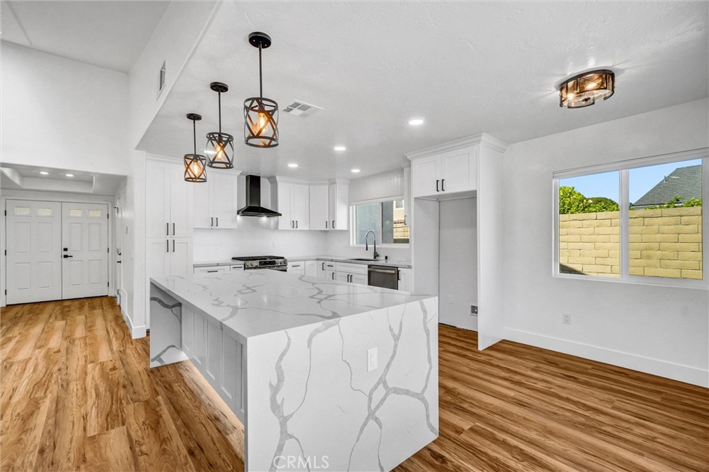 17472 Bellport Circle Huntington Beach, CA 92649 - Photo 7 of 23 a kitchen with kitchen island granite countertop a sink cabinets and stainless steel appliances