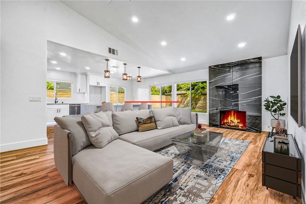 17472 Bellport Circle Huntington Beach, CA 92649 - Photo 10 of 23 a living room with furniture and a fireplace