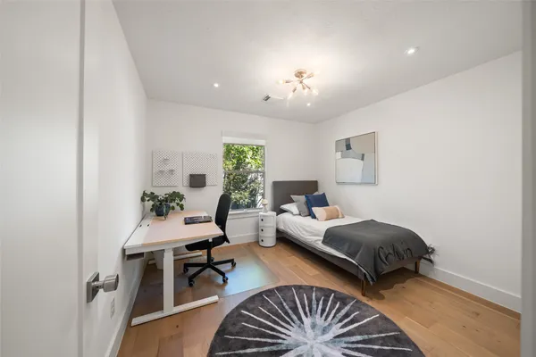 a bedroom with two beds and a chandelier