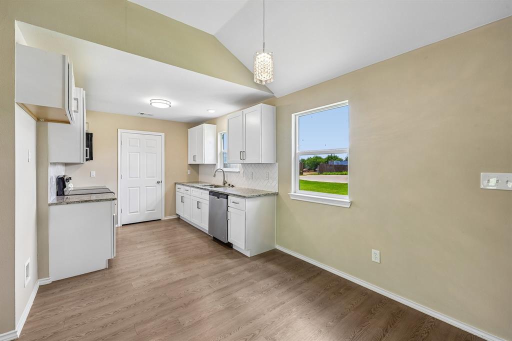 433 Whitney Court Rio Vista, TX 76093 - Photo 14 of 27 a kitchen with a refrigerator and a sink