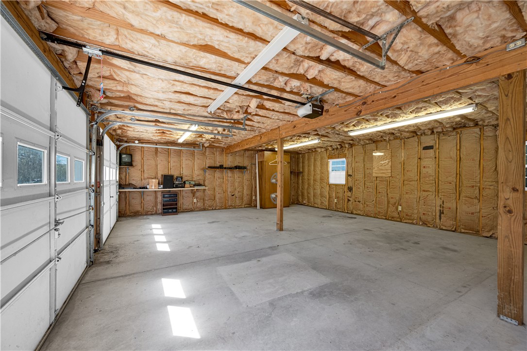 220 Bill Kay Road Belton, SC 29627 - Photo 17 of 30 Spacious garage with exposed beams and ample room for storage or vehicles.