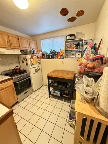a room with gym equipment and wooden floor