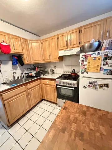 a kitchen with granite countertop a sink stainless steel appliances and cabinets