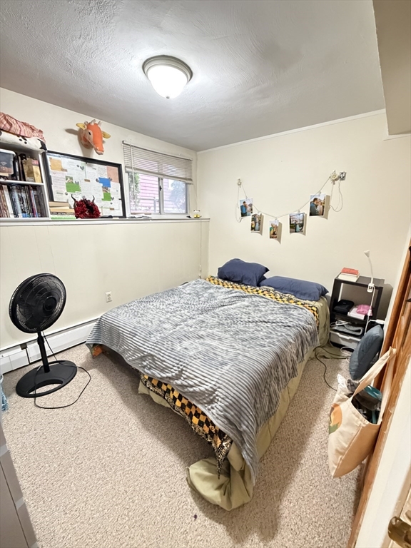 108 Perkins Street, Unit 4 Boston, MA 02130 - Photo 4 of 7 a bedroom with a bed and dresser