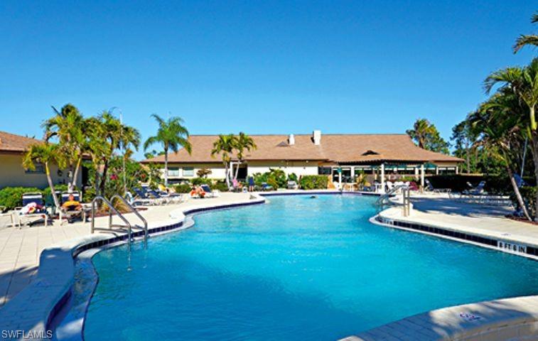 136 Harrison Road, Unit L3 Naples, FL 34112 - Photo 1 of 31 a view of a swimming pool with lounge chair