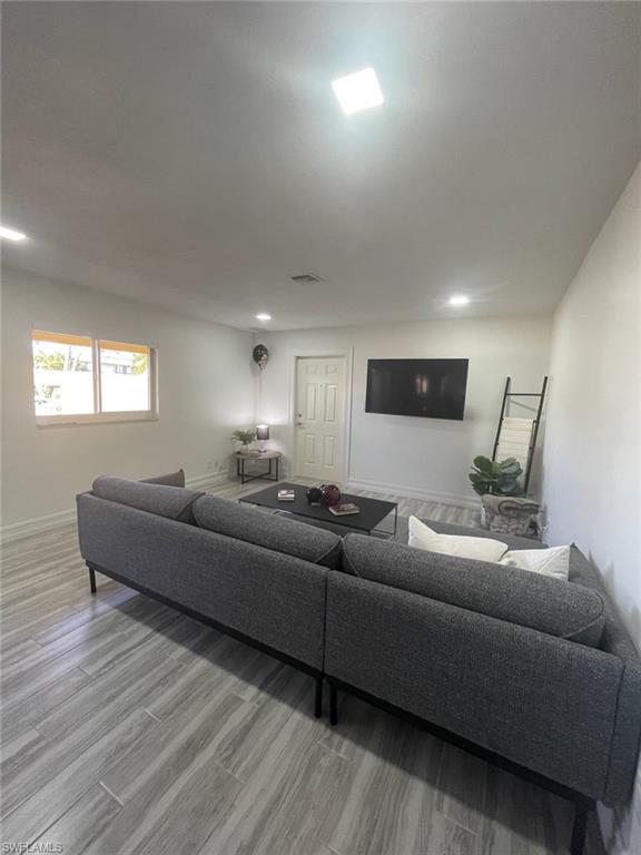 136 Harrison Road, Unit L3 Naples, FL 34112 - Photo 11 of 31 a living room with furniture and a wooden floor