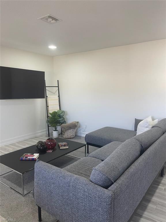 136 Harrison Road, Unit L3 Naples, FL 34112 - Photo 12 of 31 a living room with furniture and a flat screen tv