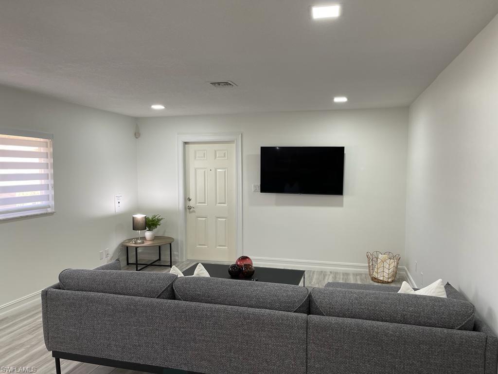 136 Harrison Road, Unit L3 Naples, FL 34112 - Photo 14 of 31 a living room with furniture and a flat screen tv