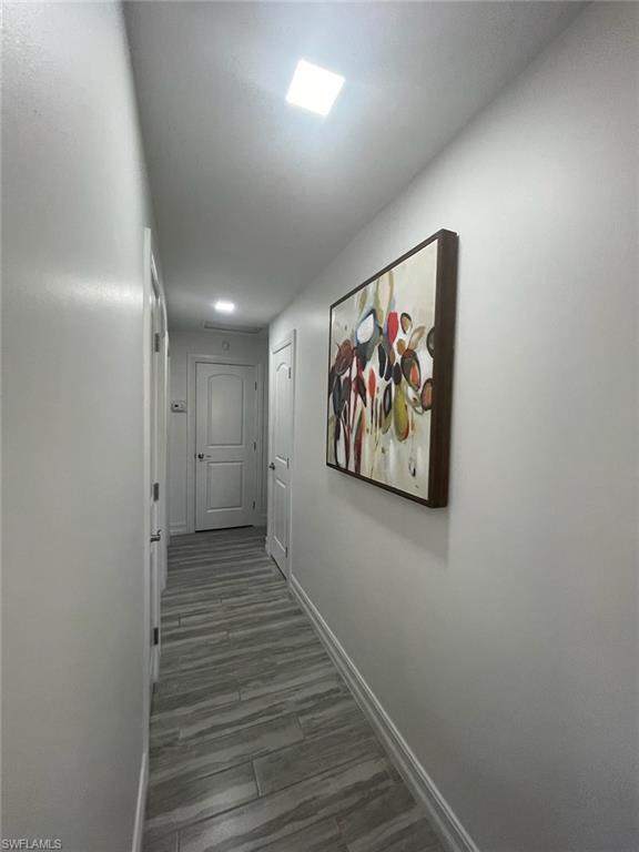 136 Harrison Road, Unit L3 Naples, FL 34112 - Photo 23 of 31 a view of a hallway with wooden floor