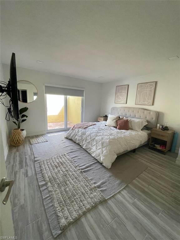 136 Harrison Road, Unit L3 Naples, FL 34112 - Photo 24 of 31 a bedroom with a bed and a view of kitchen