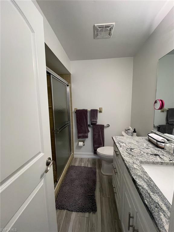 136 Harrison Road, Unit L3 Naples, FL 34112 - Photo 31 of 31 a bathroom with a granite countertop sink toilet and shower
