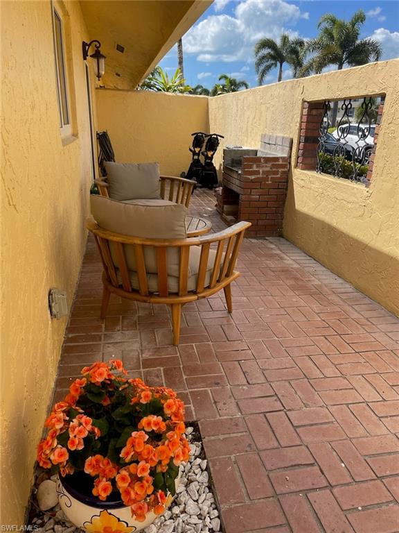 136 Harrison Road, Unit L3 Naples, FL 34112 - Photo 6 of 31 a picture of a table and chairs in a patio