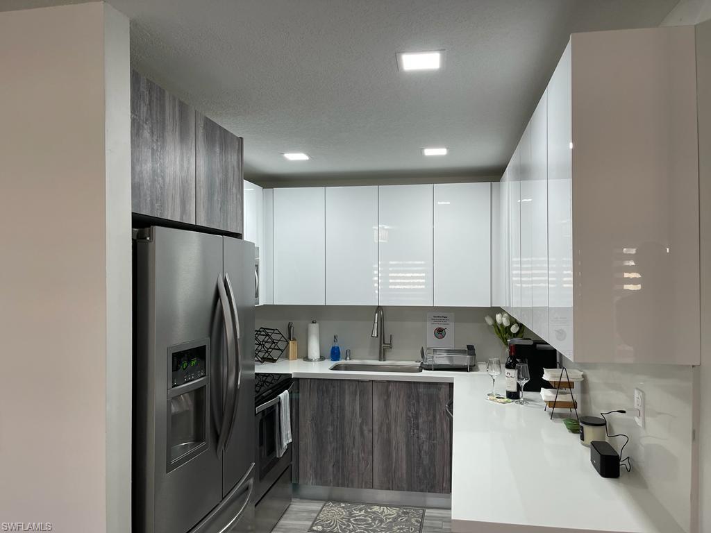 136 Harrison Road, Unit L3 Naples, FL 34112 - Photo 8 of 31 a kitchen with a refrigerator and a sink