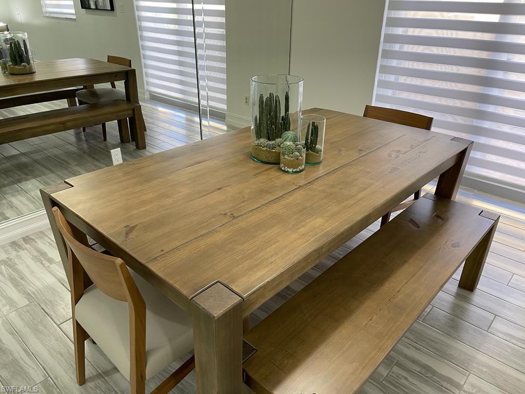136 Harrison Road, Unit L3 Naples, FL 34112 - Photo 9 of 31 a dining table with chairs and wooden floor