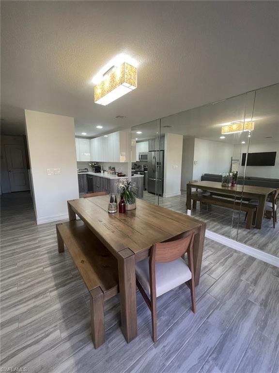 136 Harrison Road, Unit L3 Naples, FL 34112 - Photo 10 of 31 a view of a dining room with furniture and wooden floor