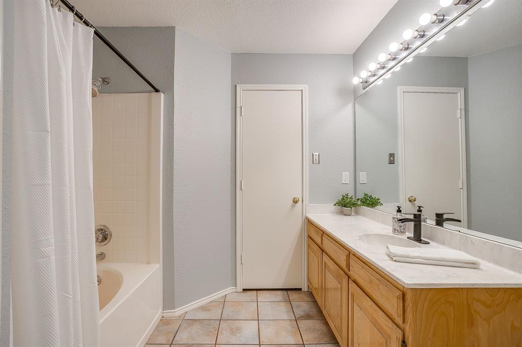 5712 Springtide Drive Fort Worth, TX 76135 - Photo 14 of 25 En suite bathroom with tub/shower