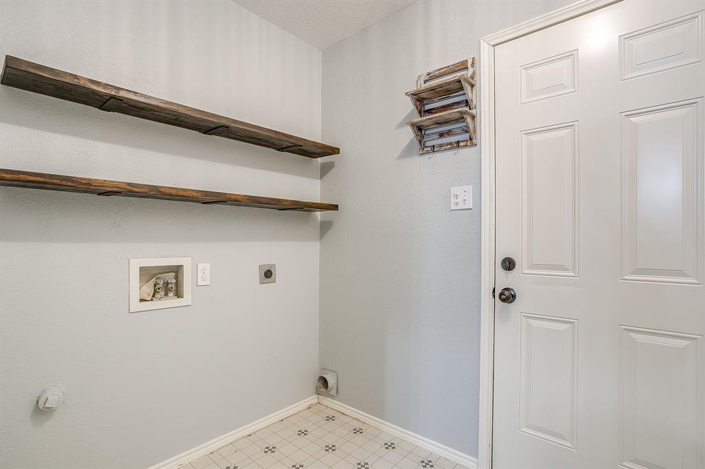5712 Springtide Drive Fort Worth, TX 76135 - Photo 22 of 25 Utility room with open shelving and washer & dryer hookups