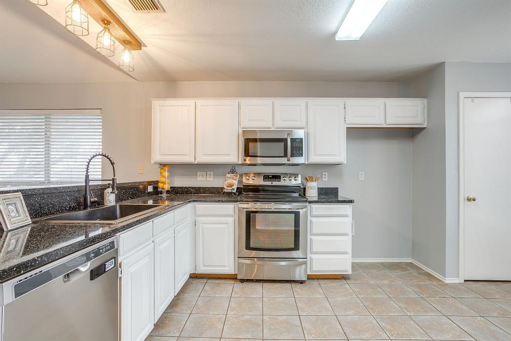 5712 Springtide Drive Fort Worth, TX 76135 - Photo 8 of 25 Stainless steel appliances with deep kitchen sink!