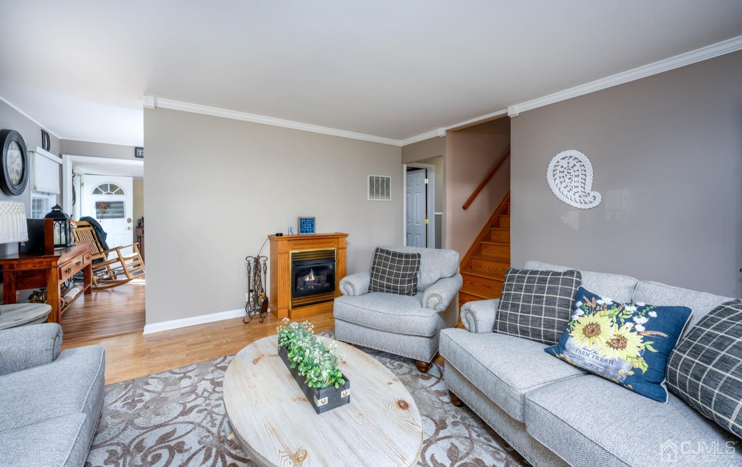 85 Idlewild Road Edison, NJ 08817 - Photo 3 of 28 a living room with furniture and a clock