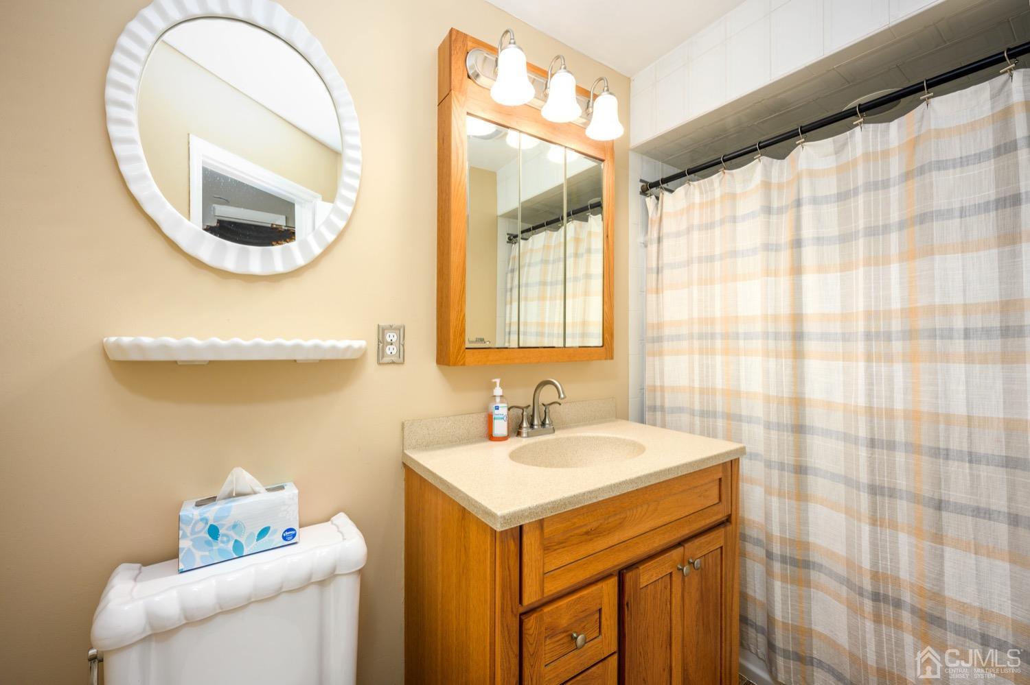 85 Idlewild Road Edison, NJ 08817 - Photo 4 of 28 a bathroom with a sink and a mirror