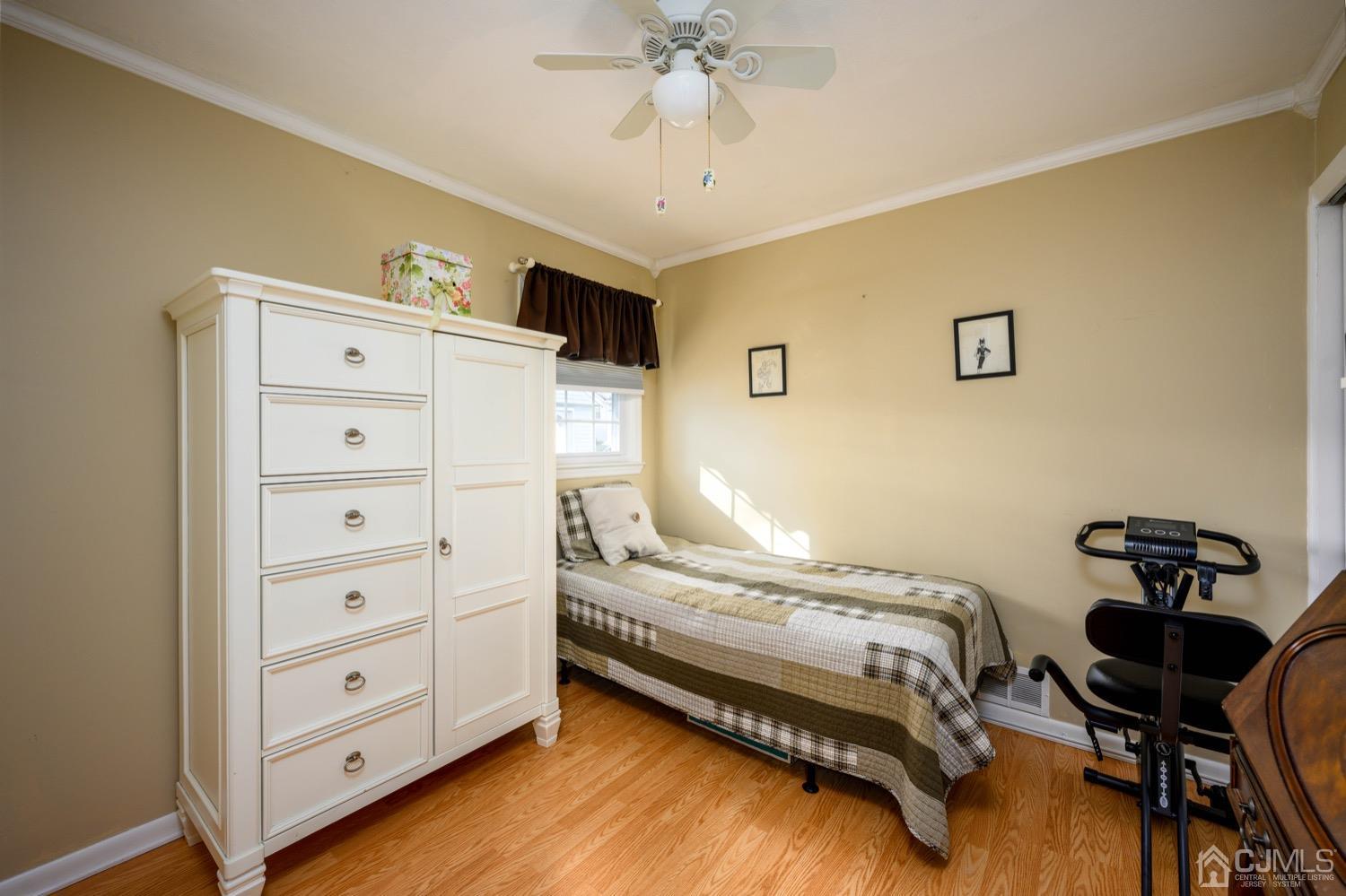 85 Idlewild Road Edison, NJ 08817 - Photo 5 of 28 a bedroom with a bed and a chandelier
