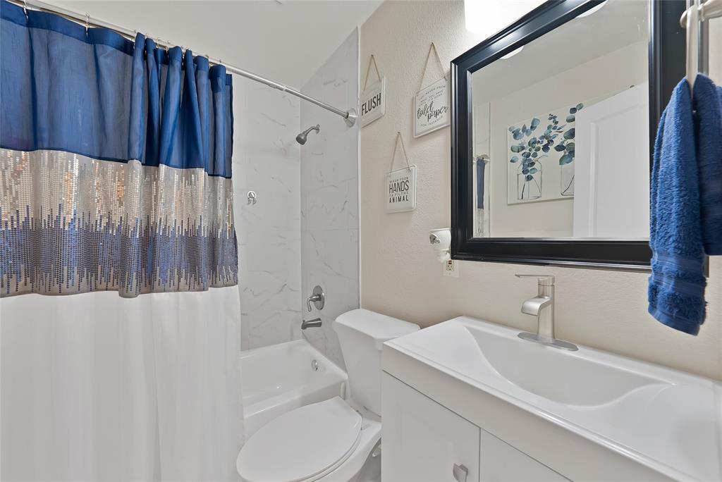 604 Moore Street Garland, TX 75040 - Photo 12 of 26 a bathroom with a sink and a mirror