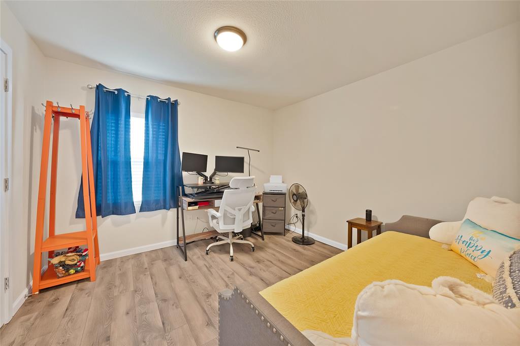 604 Moore Street Garland, TX 75040 - Photo 14 of 26 a bedroom with two beds and a desk