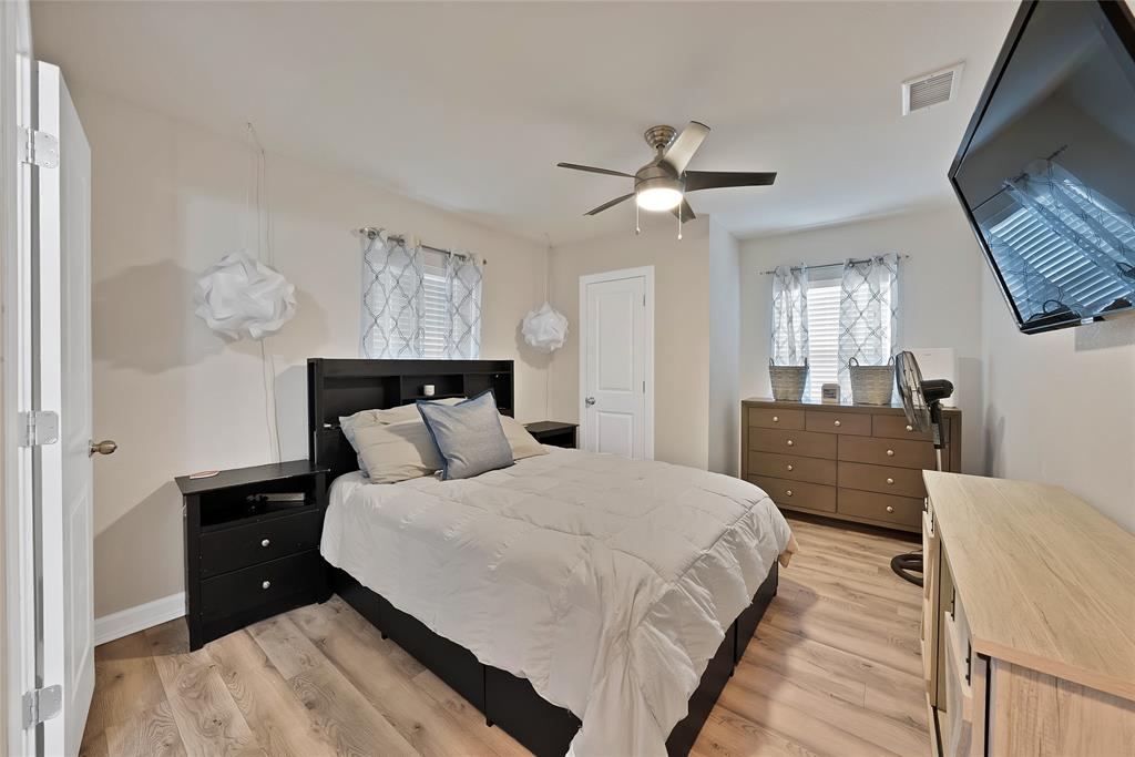 604 Moore Street Garland, TX 75040 - Photo 16 of 26 a bed room with a bed window and a mirror