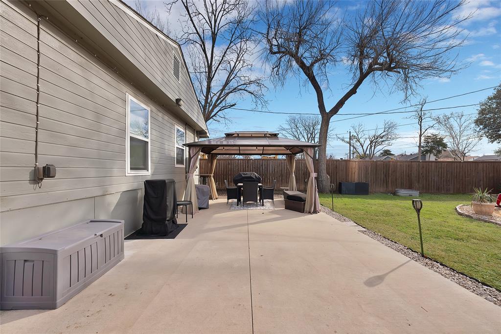 604 Moore Street Garland, TX 75040 - Photo 22 of 26 a view of a house with a yard and garage