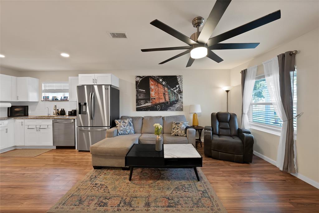 604 Moore Street Garland, TX 75040 - Photo 8 of 26 a living room with furniture a flat screen tv and a fireplace
