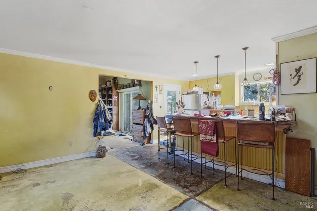 a backyard of a house with fountain table and chairs
